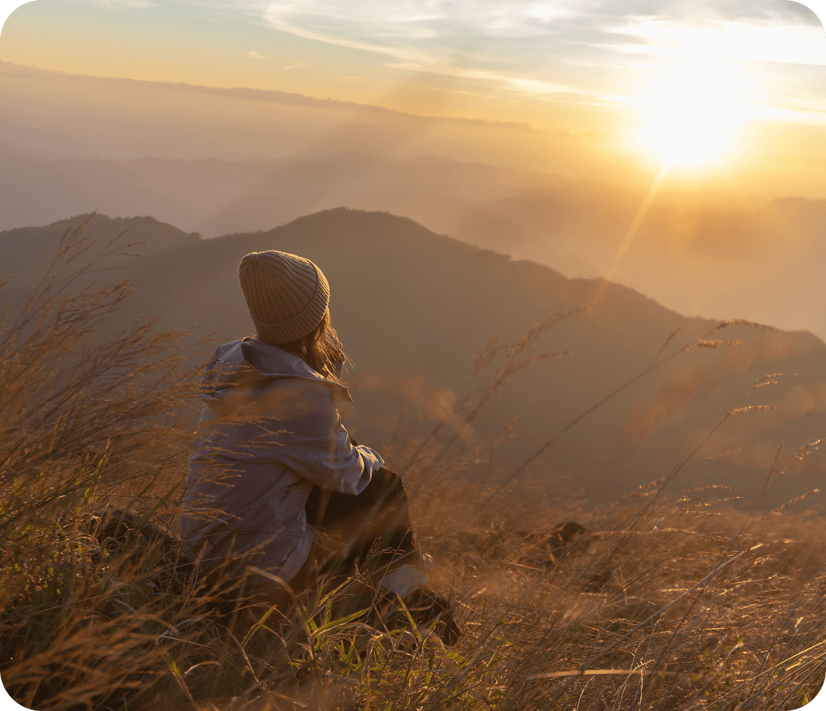 Woman enjoying mountain sunset view